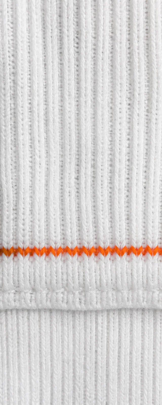 Close detail of white performance knit with orange stitching